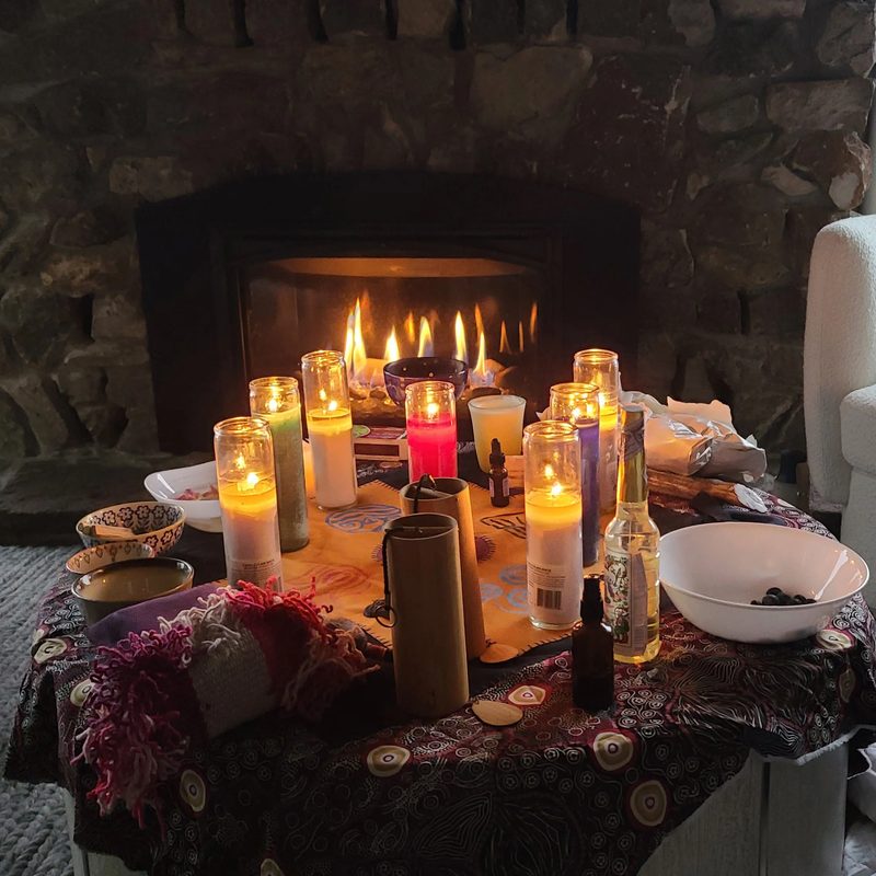 A retreat table set in front of a fireplace with candles and bowls